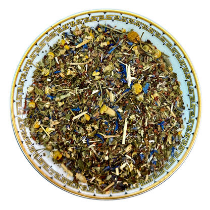 Herbal tea mix on a decorative plate with a white background