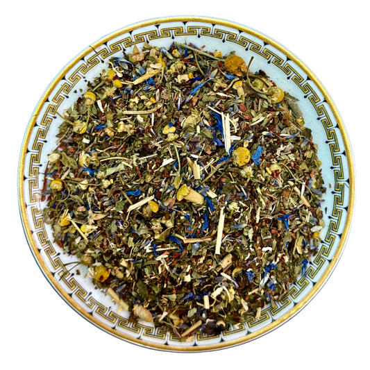 Herbal tea mix on a decorative plate with a white background