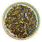 Herbal tea mix on a decorative plate with a white background
